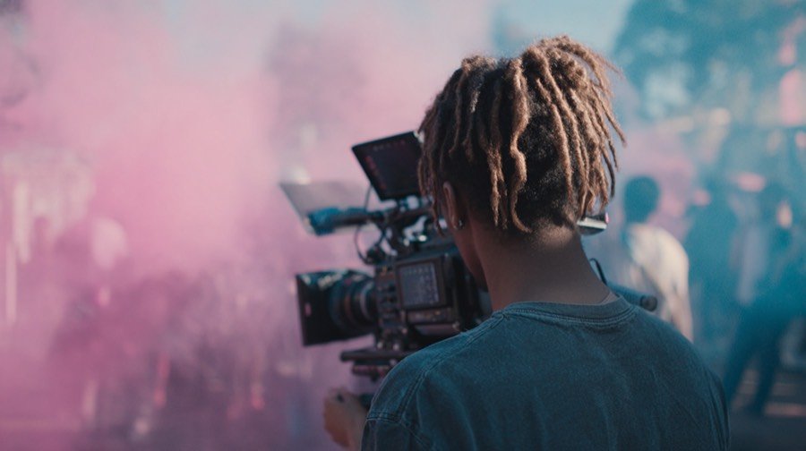 An operator shooting handheld through coloured smoke